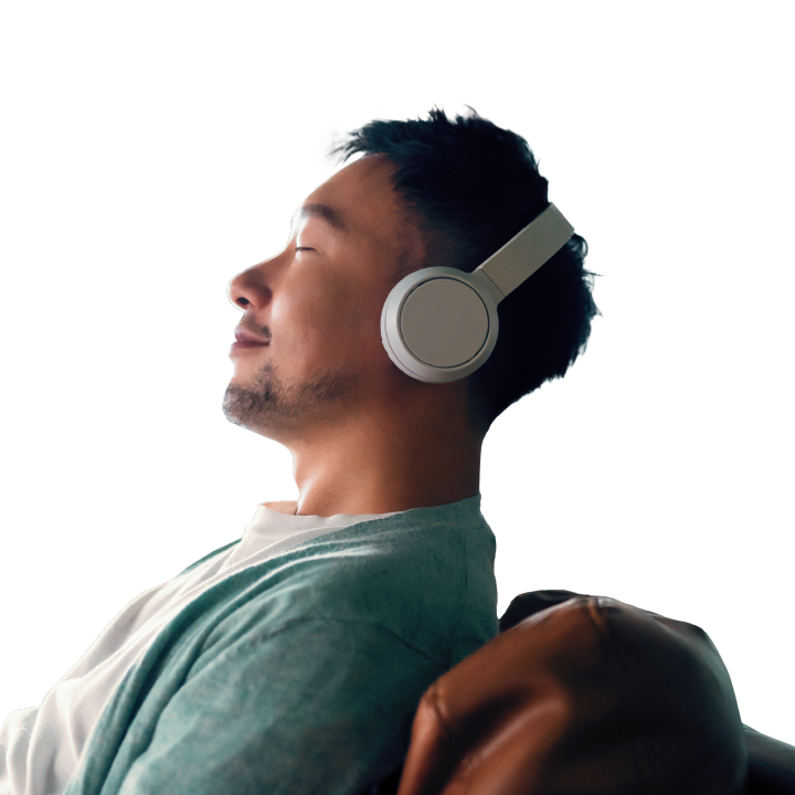 young man with headphones relaxing on his sofa